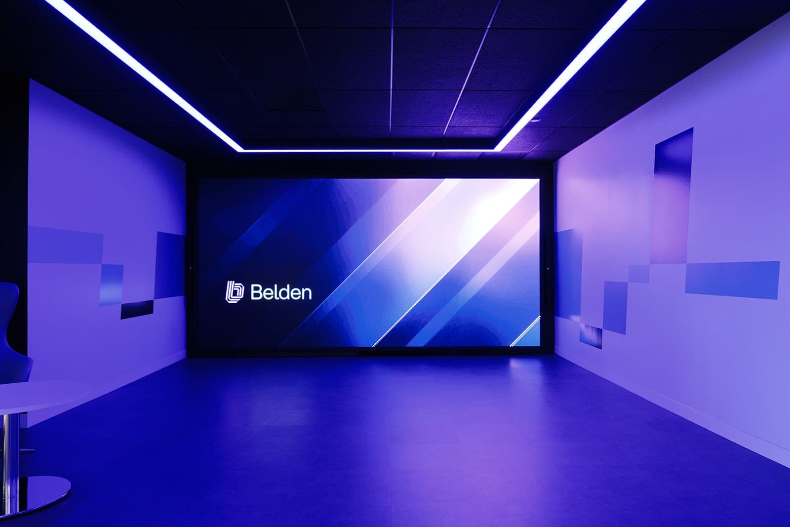 The Belden LED video wall glowing in an otherwise dark purple room, corporate interior photography of a technology experience space in St. Louis