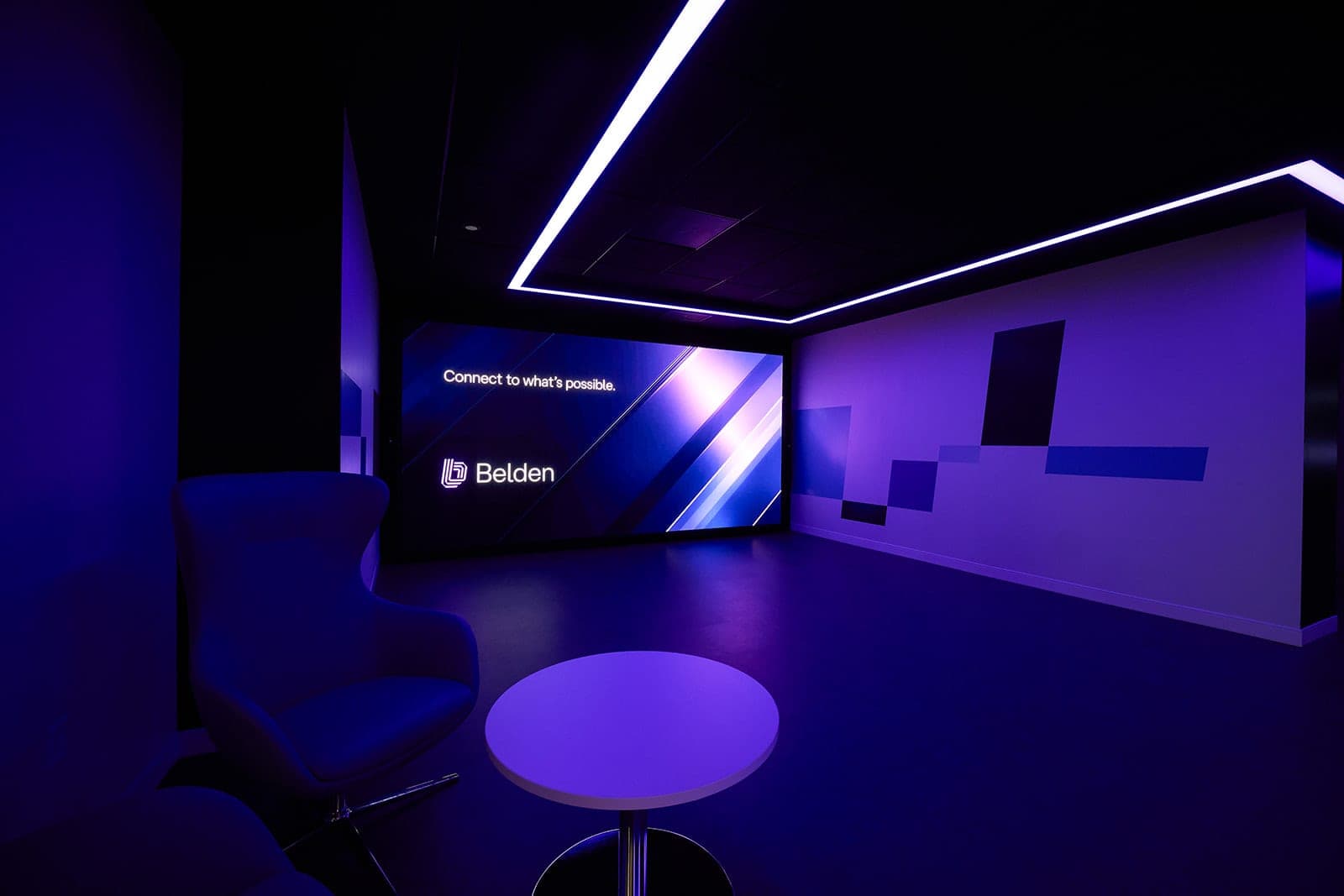 The wood-topped interactive touch table in the foreground with the Belden LED video wall behind it, commercial interior photography in St. Louis