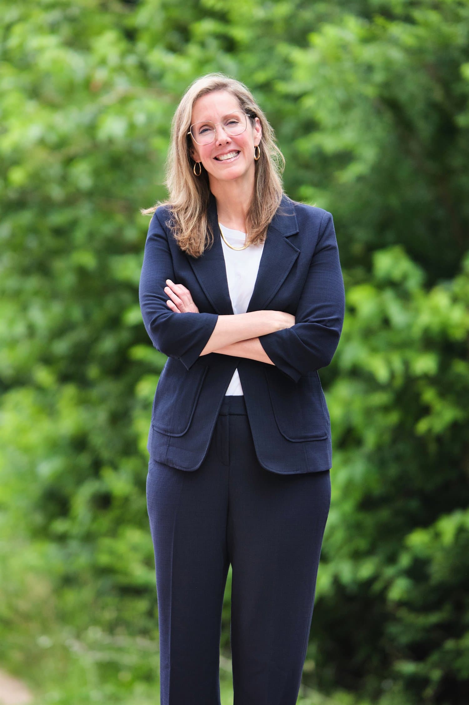 Environmental outdoor portrait of a public-facing candidate against greenery