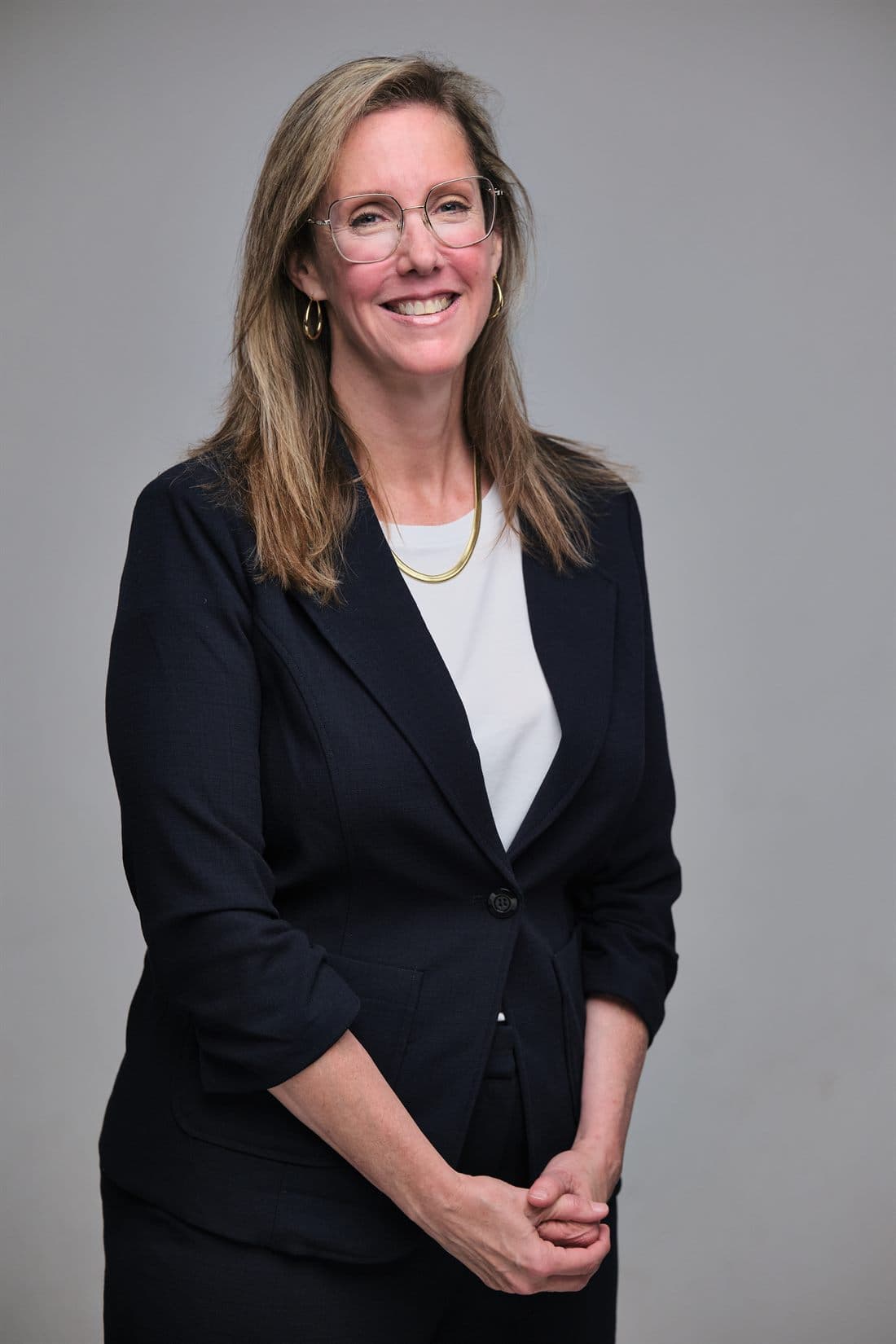Standing studio portrait of a public-facing candidate with controlled lighting
