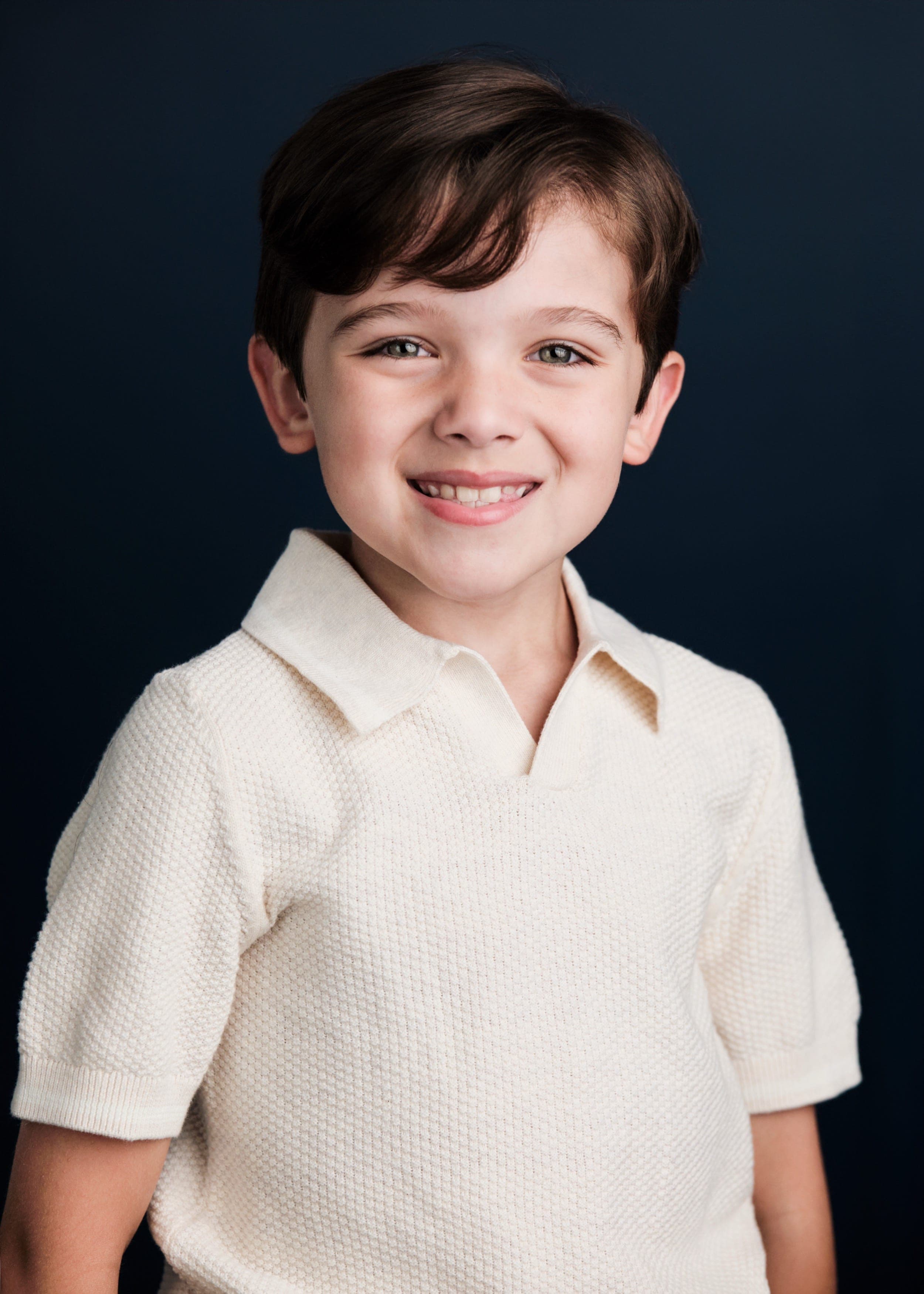 Professional children's portrait with warm studio lighting by Henry David Photography