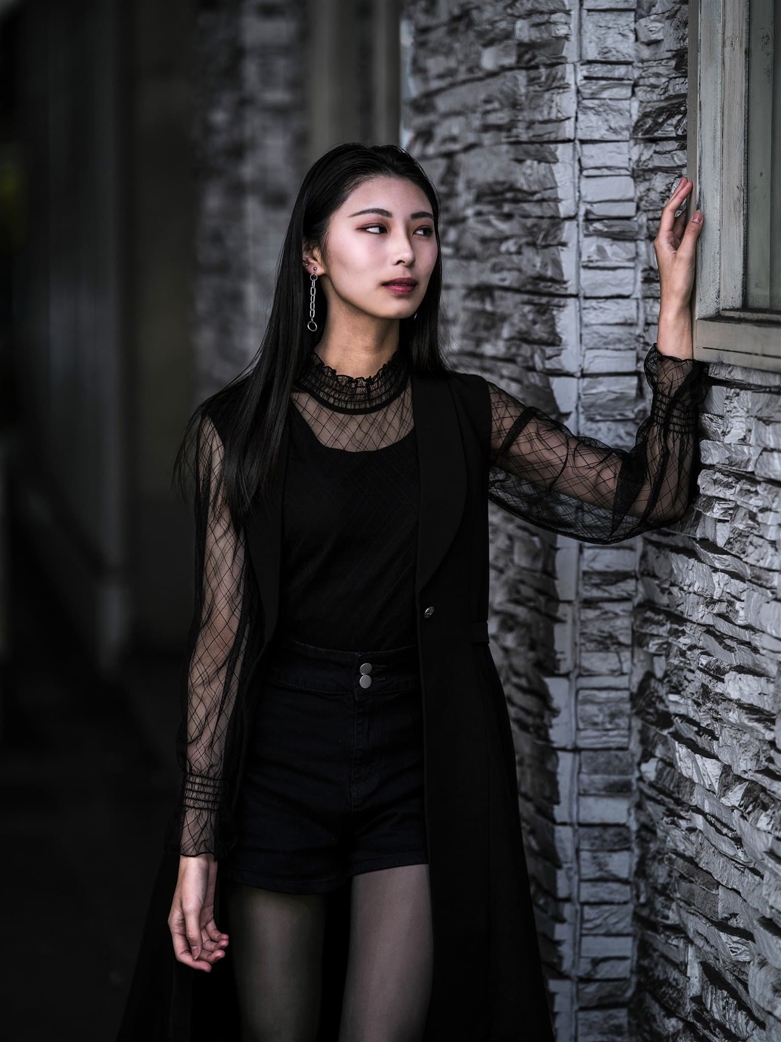 Anna photographed beside a stone wall in Osaka