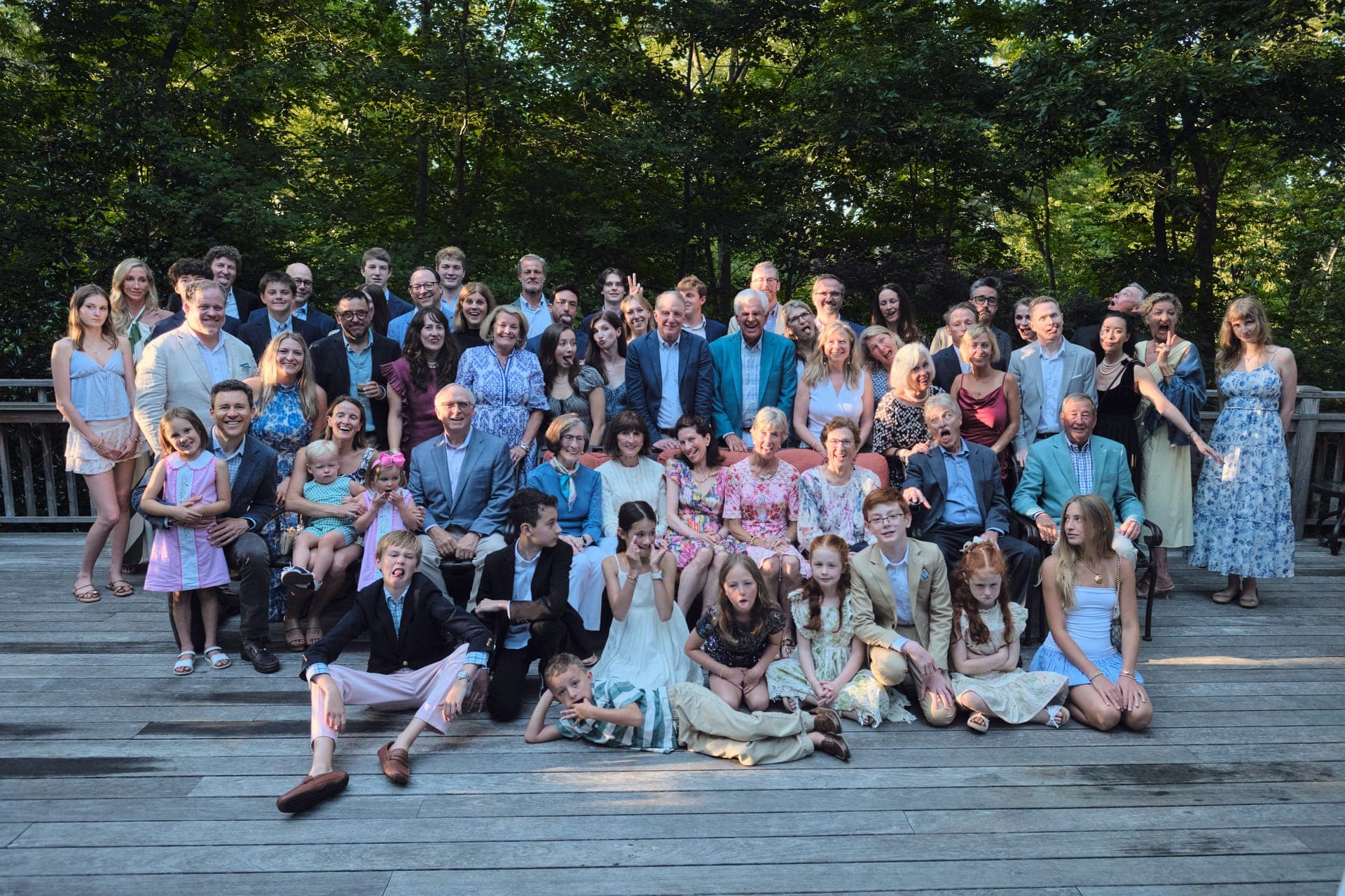 An extended family gathers for a group portrait with children in front at Deer Creek Club