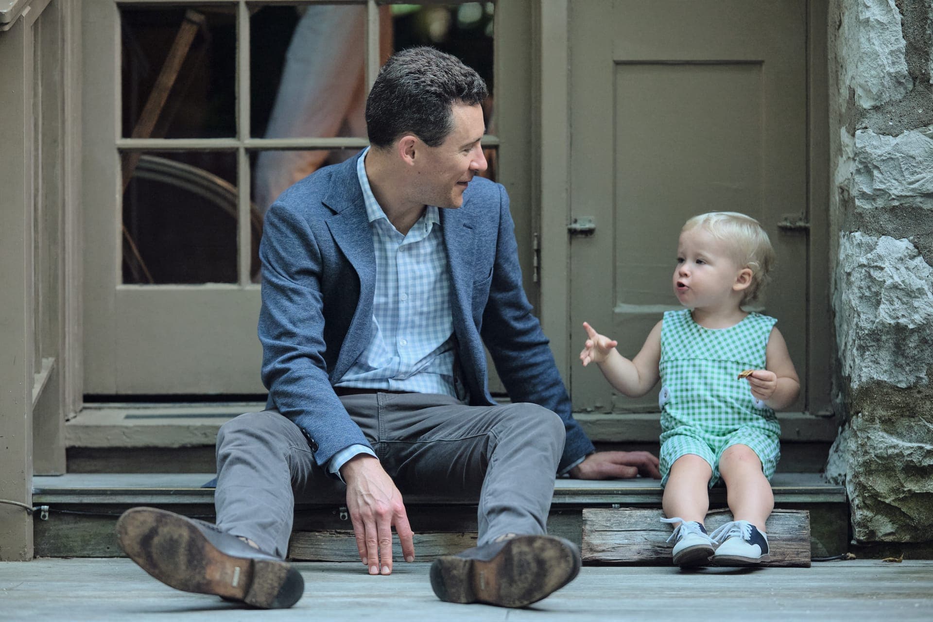 A father and his toddler share a moment on the stone steps at Deer Creek Club in Ladue