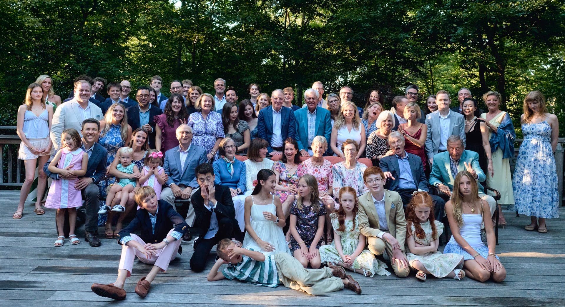 The full family gathers on the Deer Creek Club deck for a group photo at golden hour in Ladue