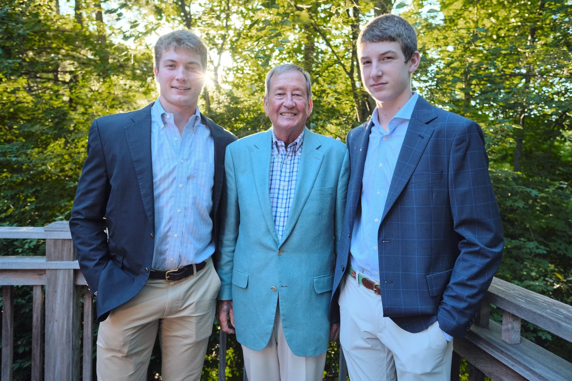 A grandfather stands between his two grandsons for a portrait at Deer Creek Club in Ladue