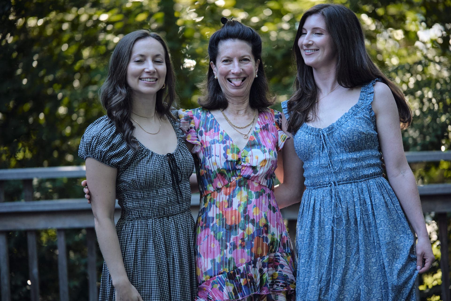 A mother laughs between her two daughters for a portrait at a family reunion in Ladue