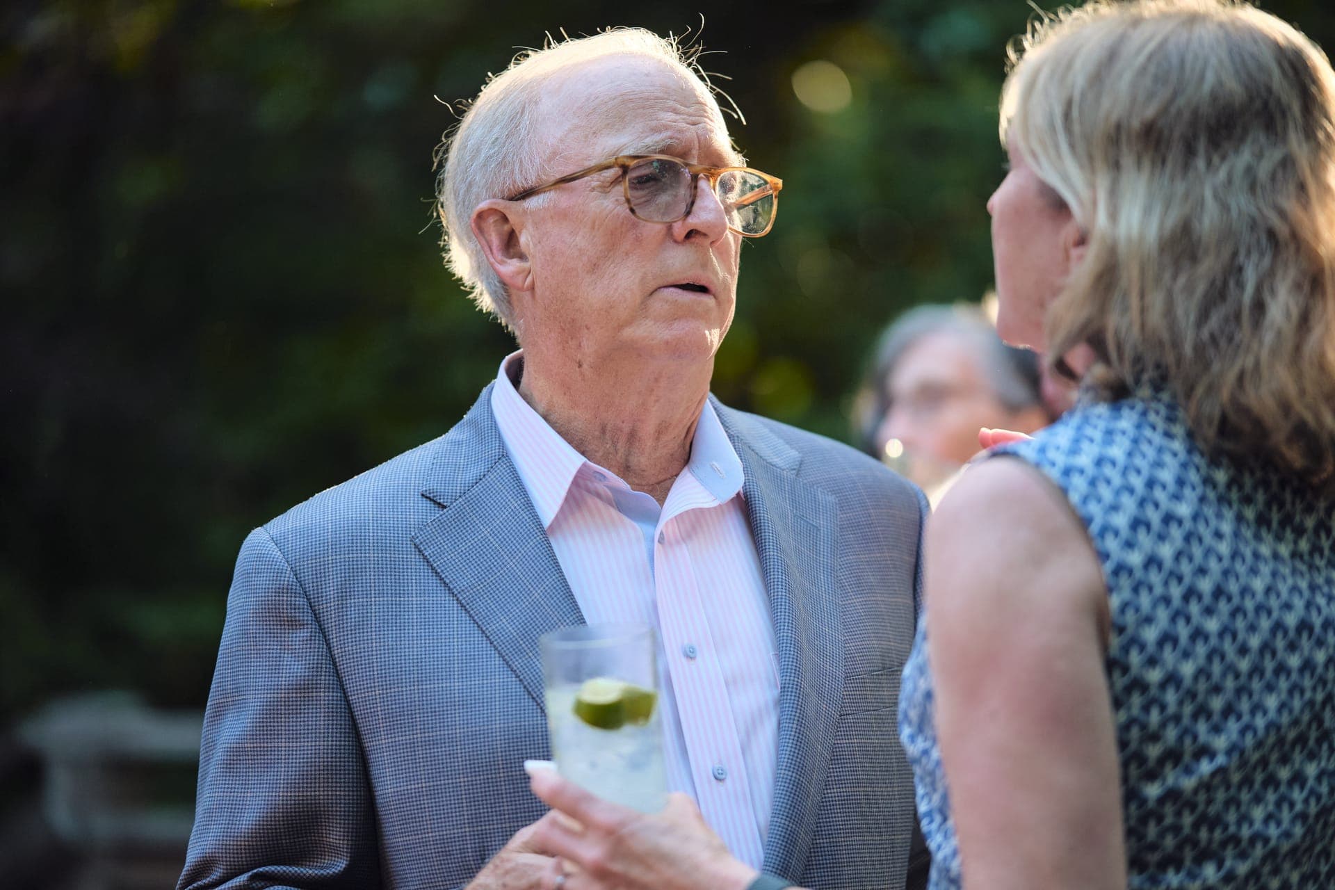 An older couple smiles face to face in golden light at a family reunion in Ladue