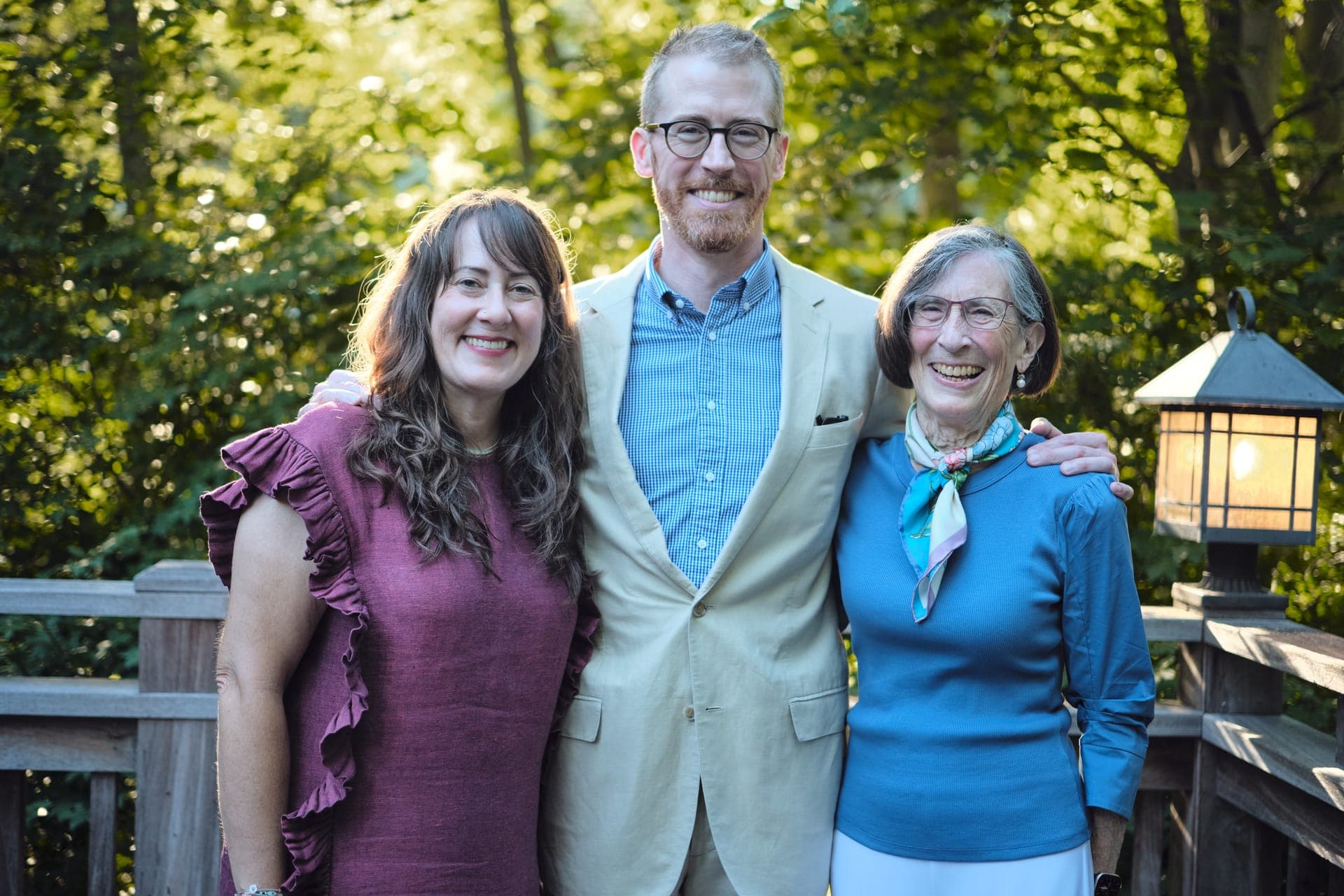Three generations laugh together for a portrait at a family reunion in Ladue