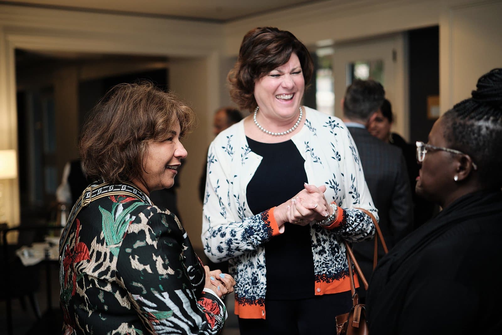 Two guests share a laugh during a networking break at the US India Business Council conference in St. Louis