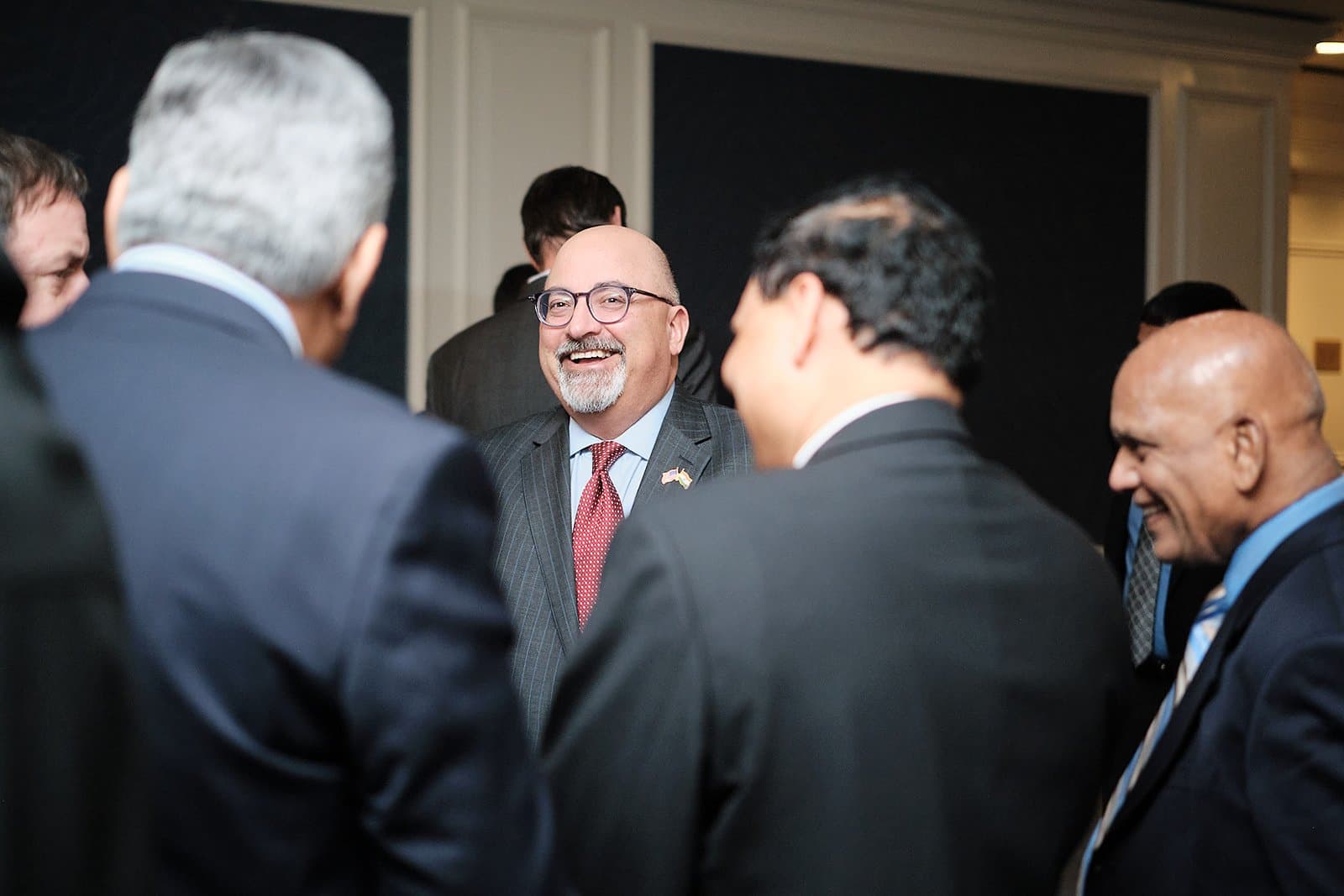 Smiling guests in conversation at a US India Business Council reception in St. Louis