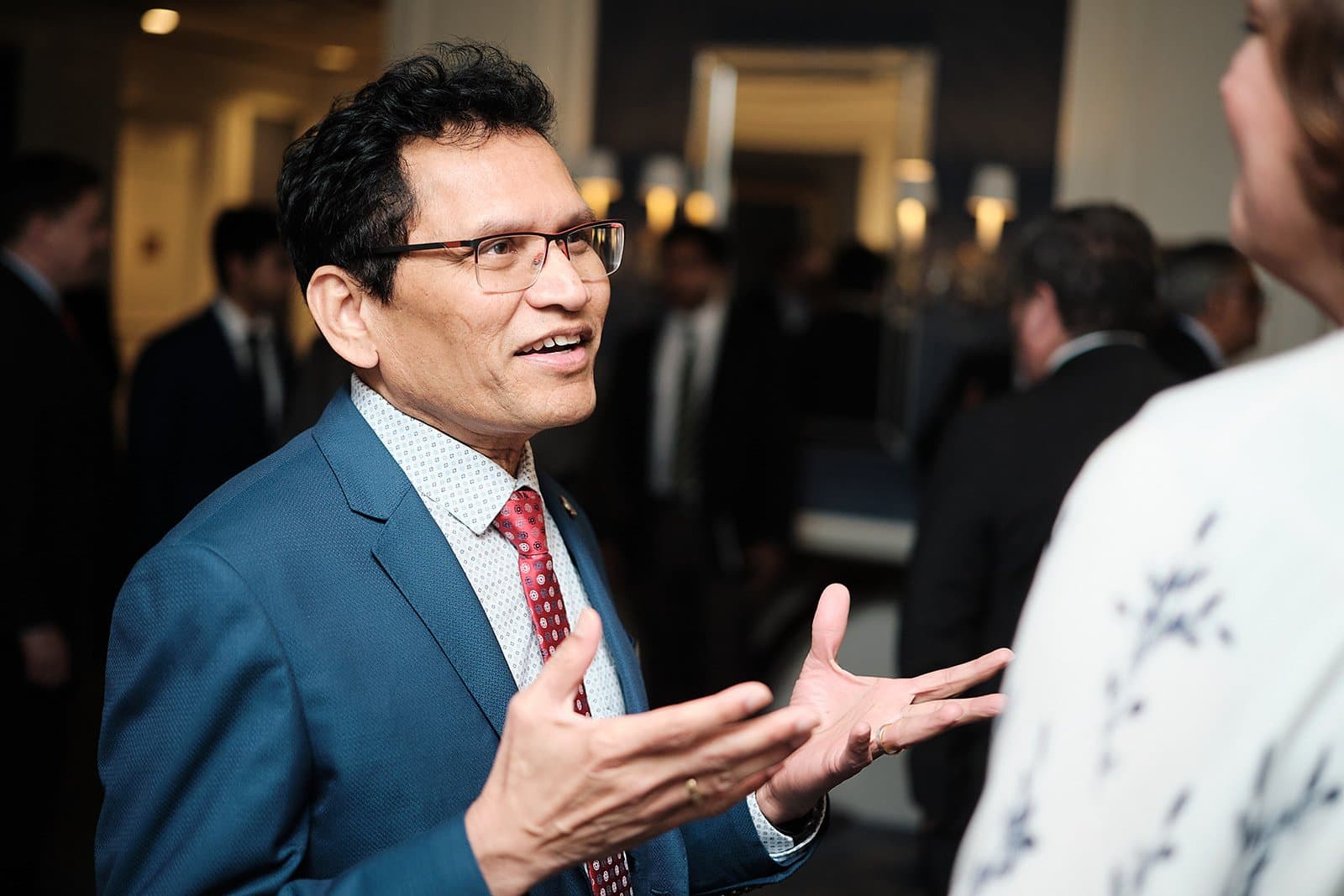 A guest gestures mid-conversation at a US India Business Council reception in St. Louis