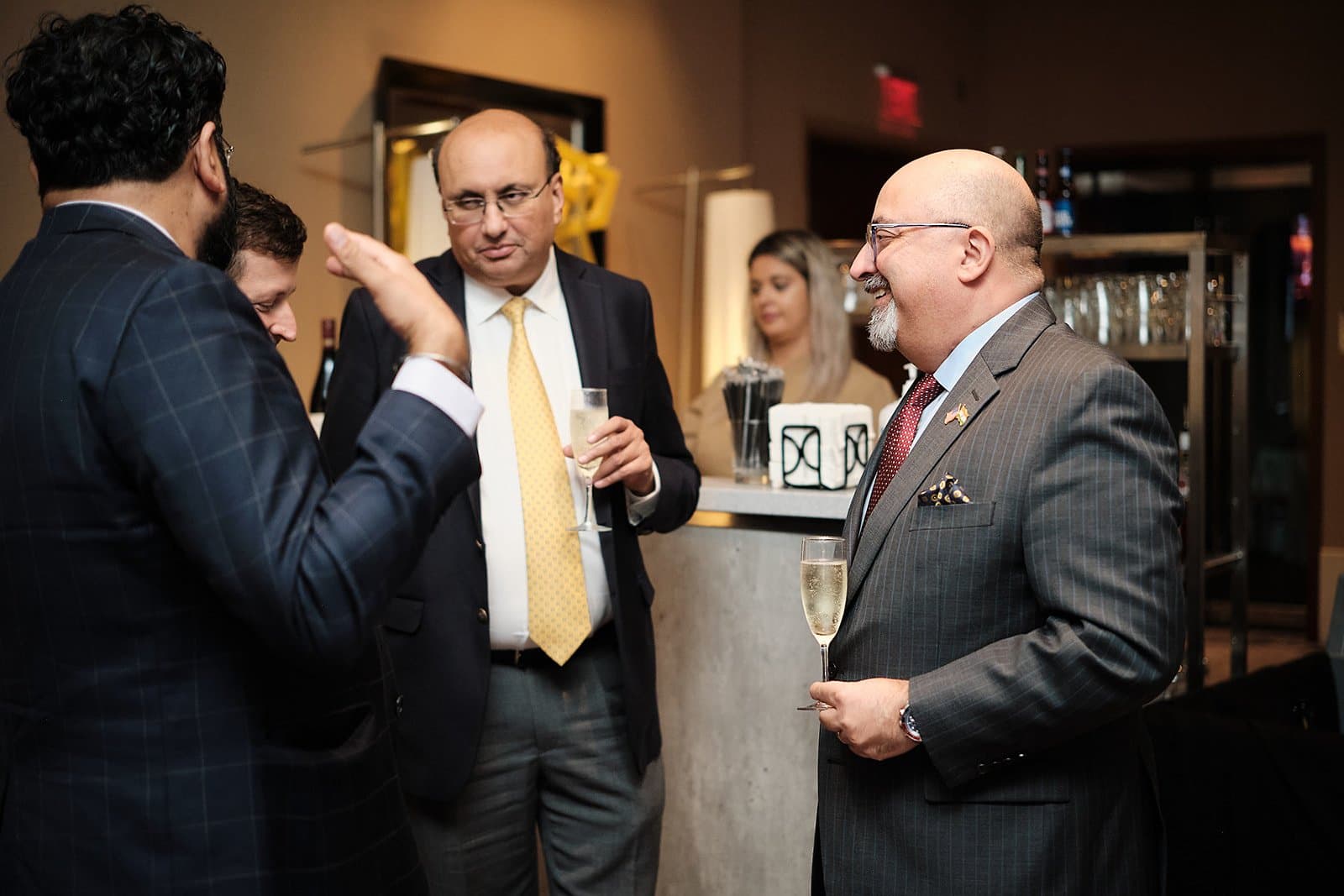 Guests talk near the bar during an evening reception at the US India Business Council conference in St. Louis