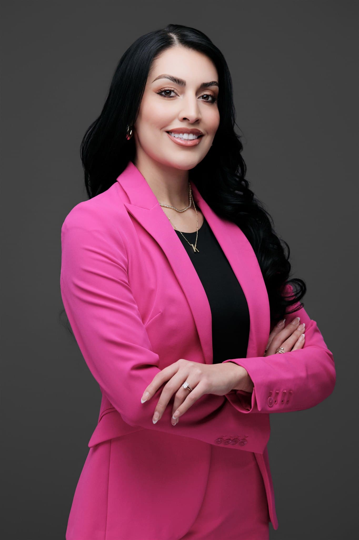 Corporate employee headshot photographed against neutral gray backdrop, the kind of consistent portrait used in recruiting microsites and careers pages