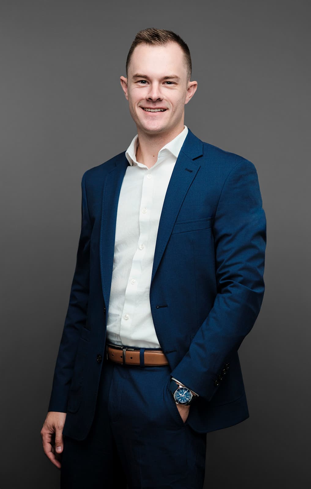 Northwestern Mutual executive in dark suit photographed against gradient gray backdrop with three-point studio lighting at Henry David Photography St. Louis studio