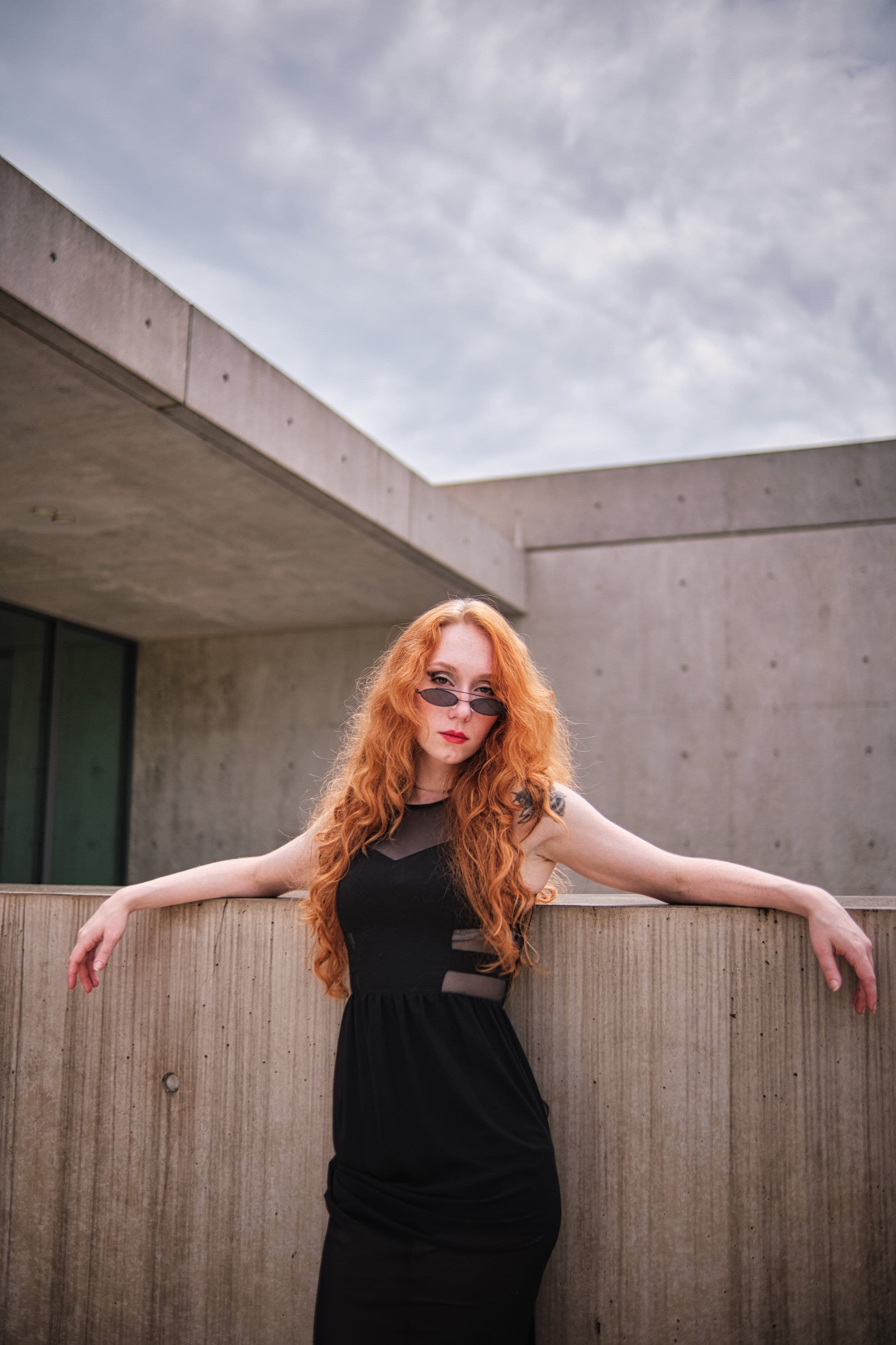 Outdoor portrait, red-haired woman in sunglasses at a concrete wall by Henry David Photography, the standard every Kirkwood headshot session is held to