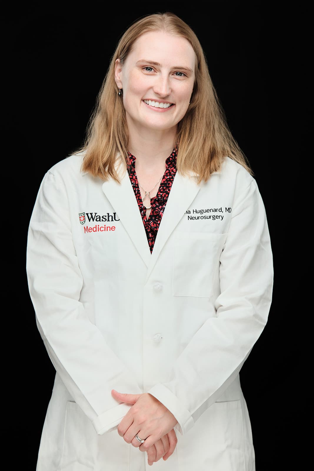 Dr. Anna Huguenard, MD, Neurosurgery . White coat headshot at Washington University School of Medicine by Henry David Photography