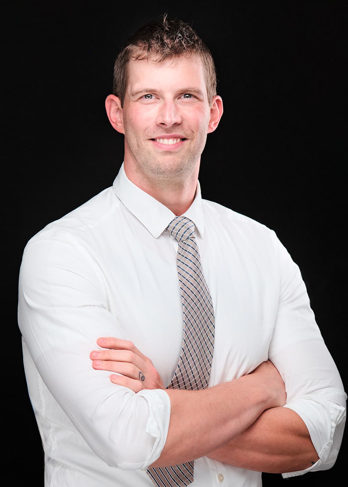 Dr. Bradley Budde, WashU Neurosurgery, white coat headshot on black backdrop by Henry David Photography