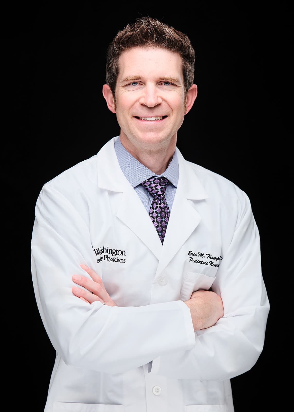 Dr. Eric Thompson, Pediatric Neurosurgery . White coat headshot at Washington University School of Medicine by Henry David Photography