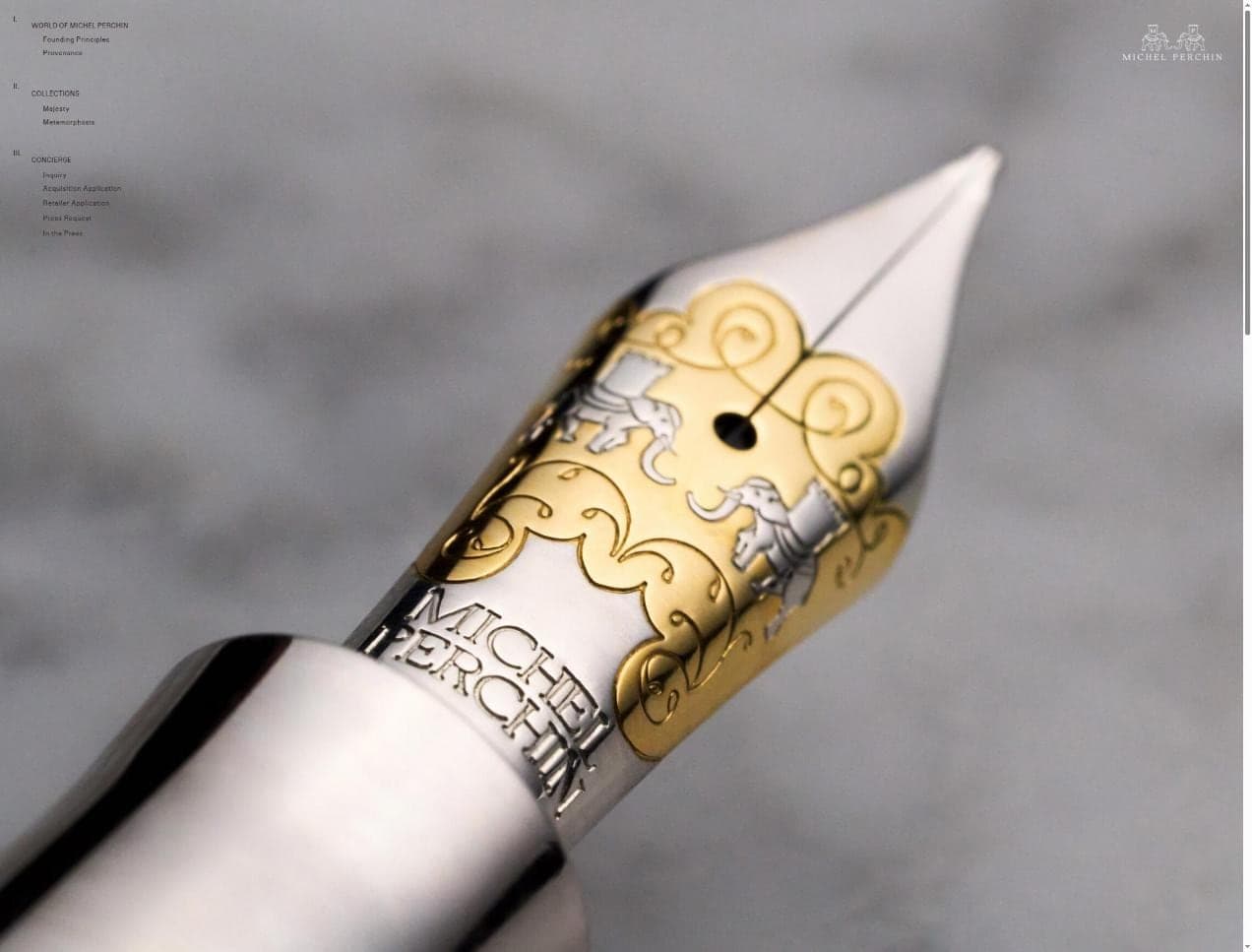 The Michel Perchin about page led by a macro photograph of the house nib, its elephant crest engraved in gold, shot by Henry David Photography