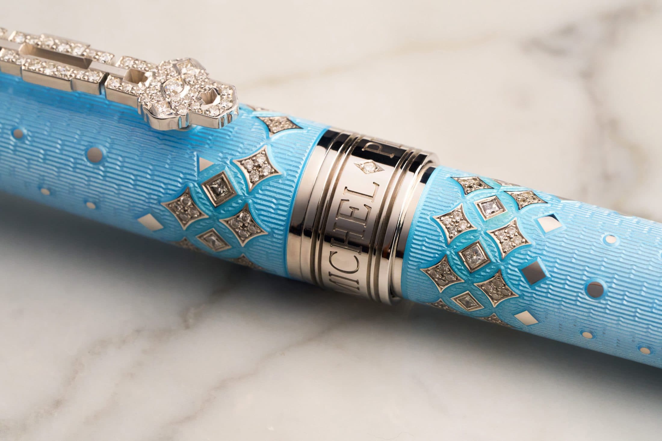 Macro detail of the Michel Perchin name rendered in relief on a Majesty fountain pen