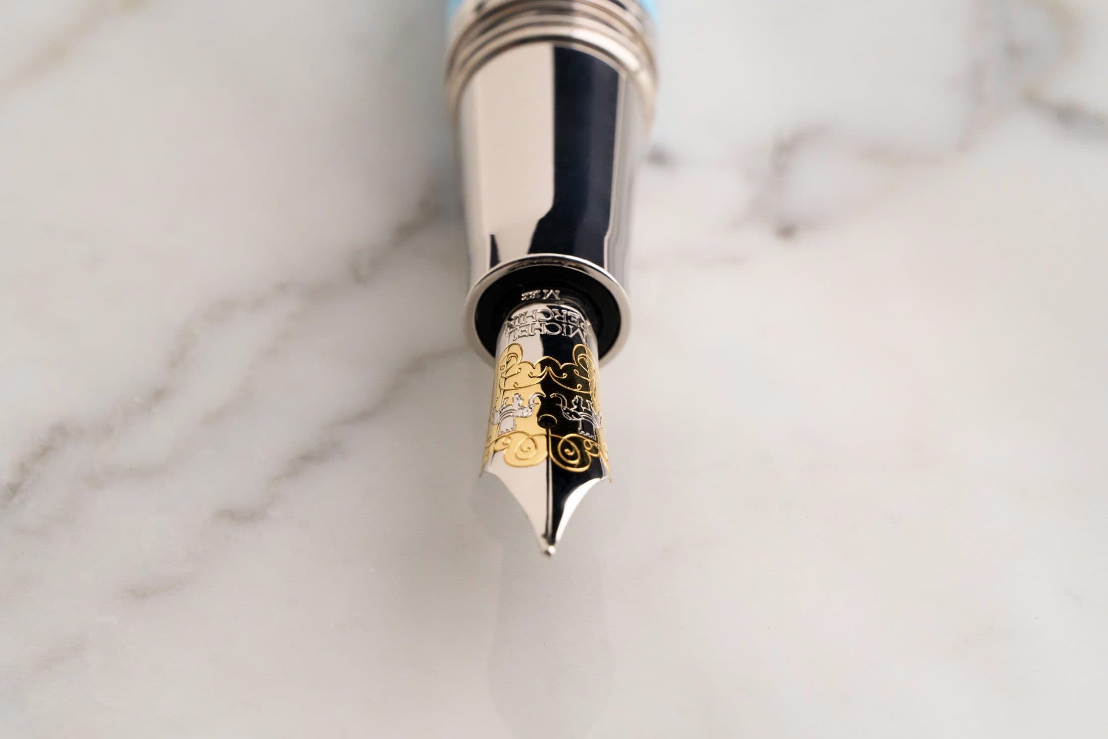 Macro of a Michel Perchin Majesty fountain pen nib over a black ground