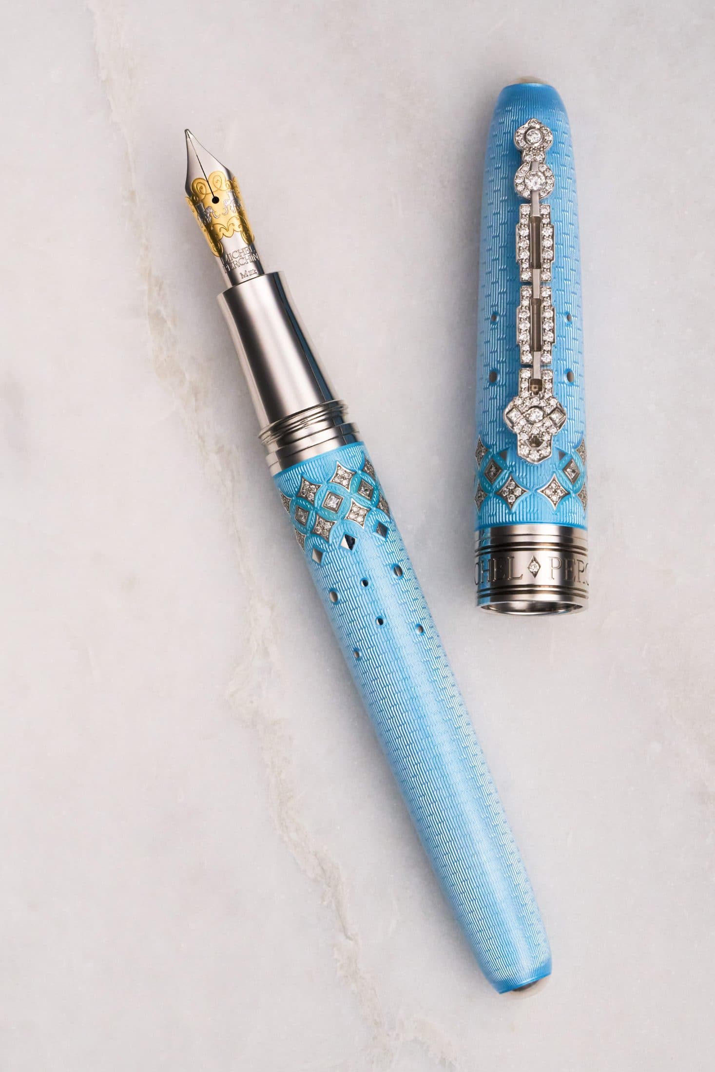 Michel Perchin Majesty periwinkle fountain pen with cap and barrel parted, on Carrara marble