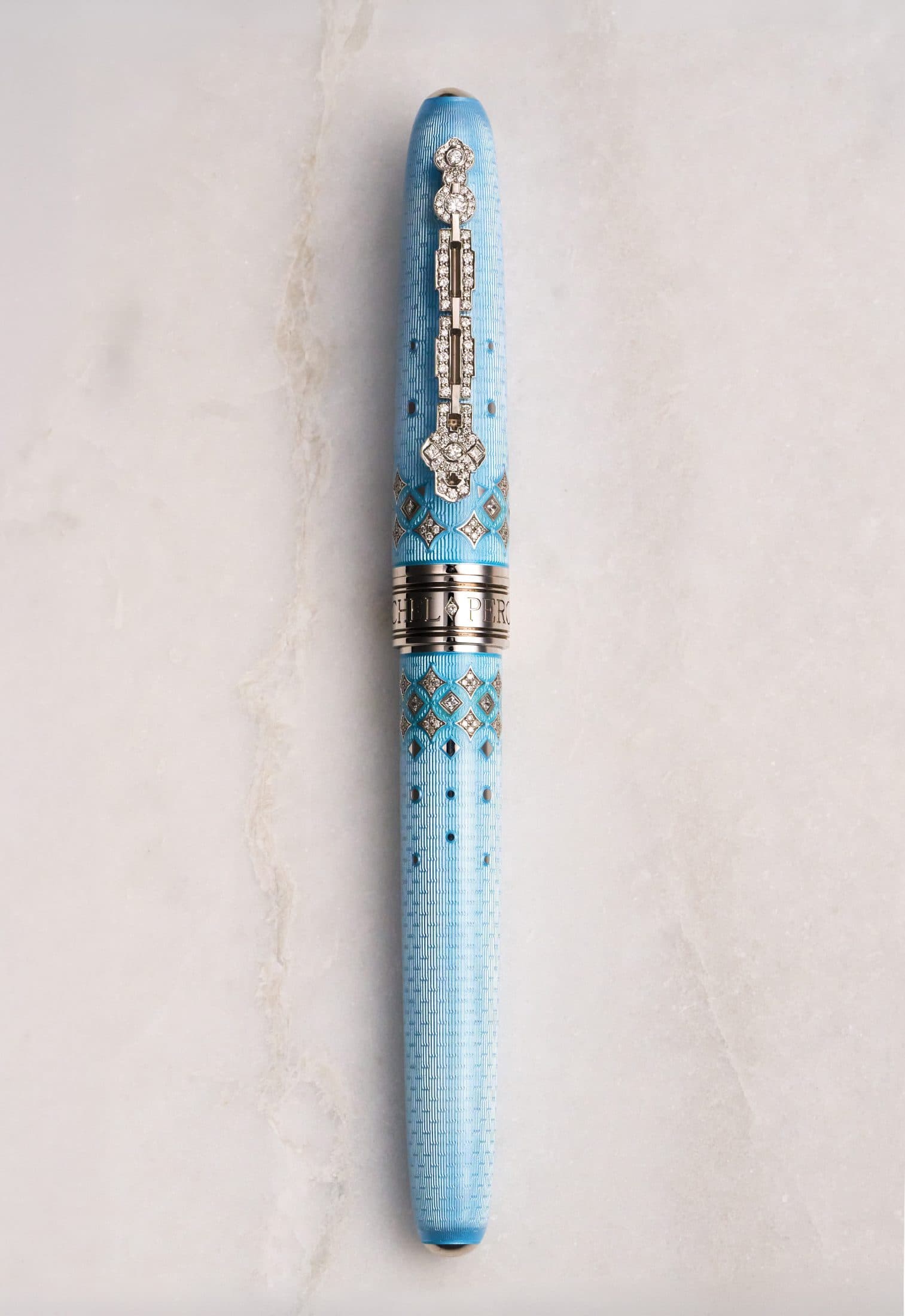 Michel Perchin Majesty blue guilloche enamel fountain pen, full length on Carrara marble