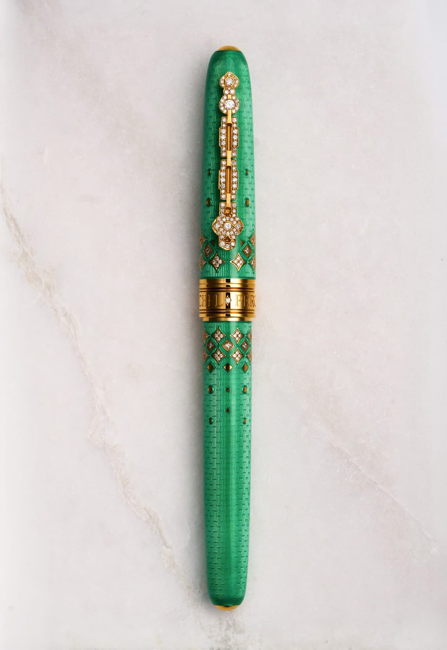 Michel Perchin Majesty green guilloche enamel fountain pen with diamond-set clip, full length on Carrara marble