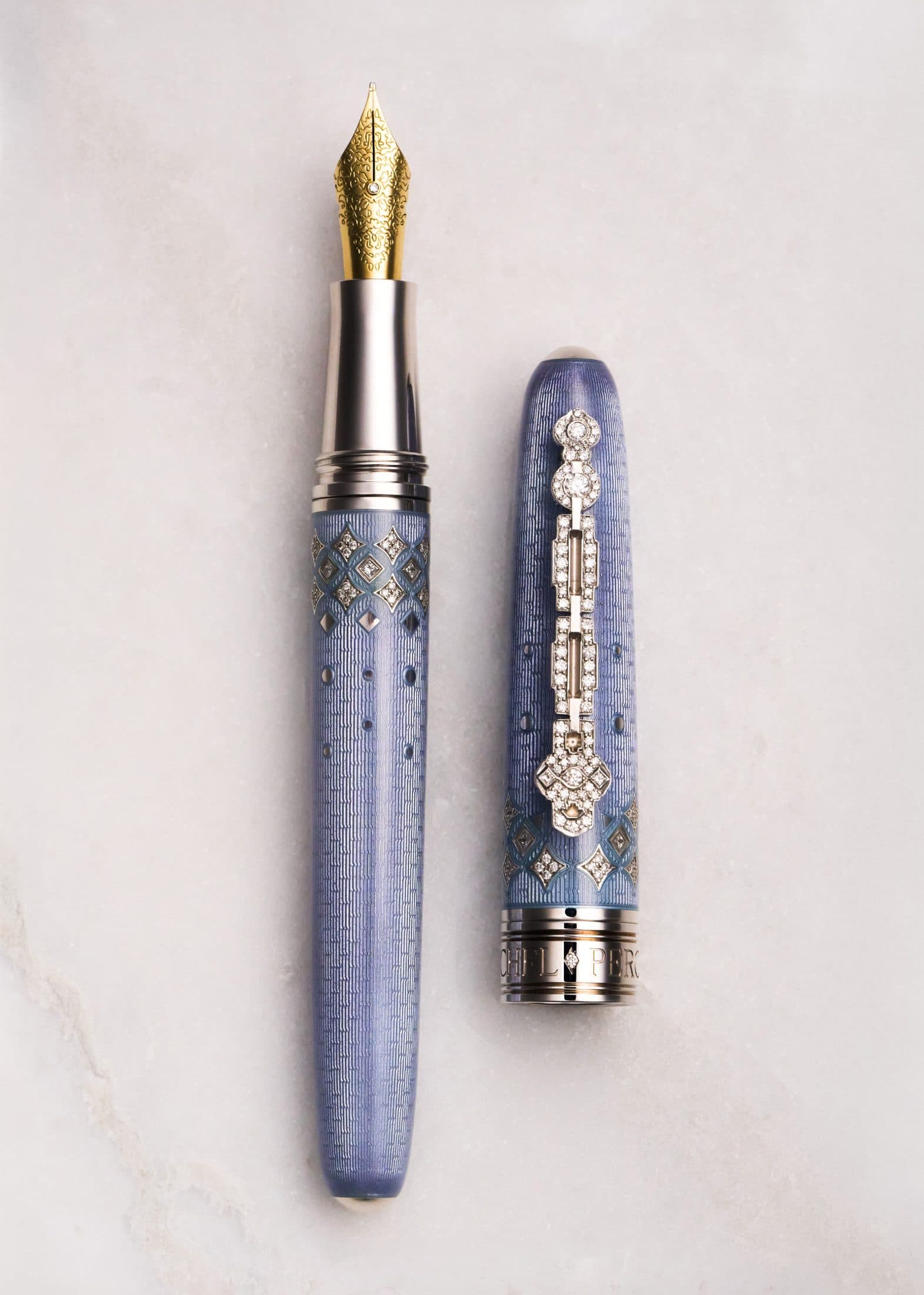 Michel Perchin Majesty periwinkle fountain pen with cap and barrel parted on Carrara marble