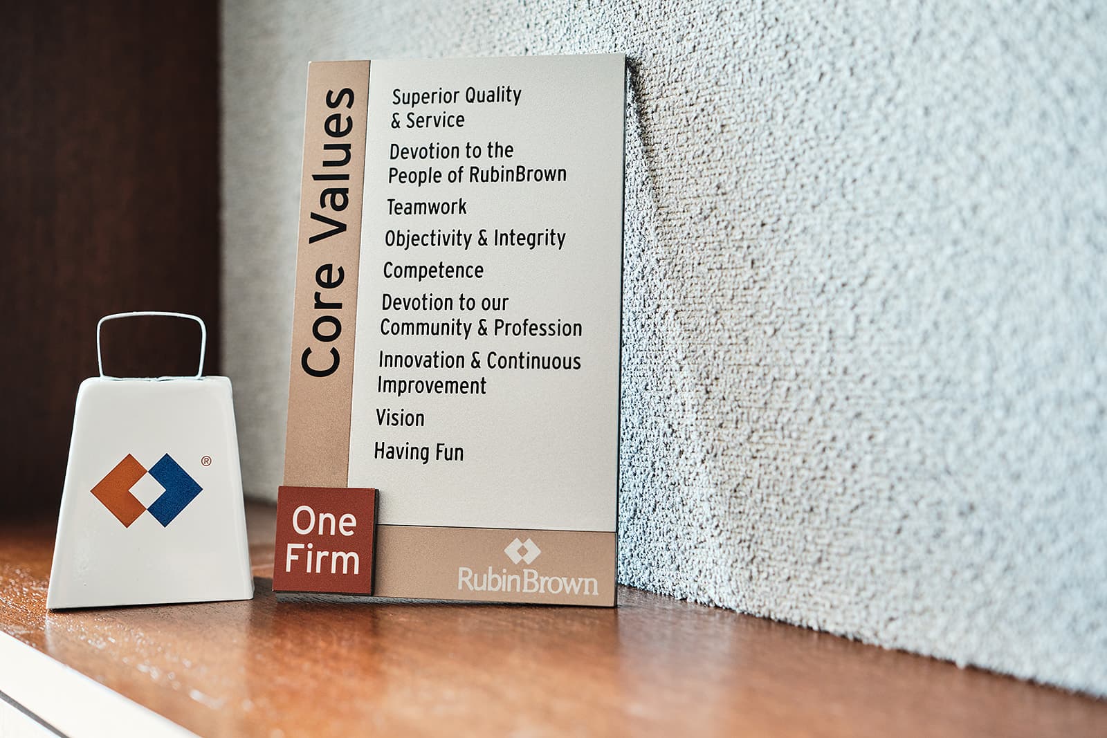 RubinBrown branded cowbell award and core values product photography by Henry David Photography