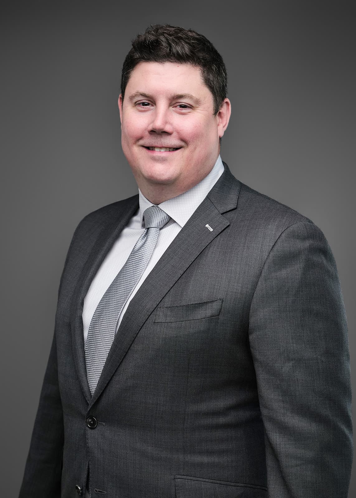 Professional corporate headshot of a RubinBrown team member, photographed on a consistent studio setup by Henry David Photography in St. Louis