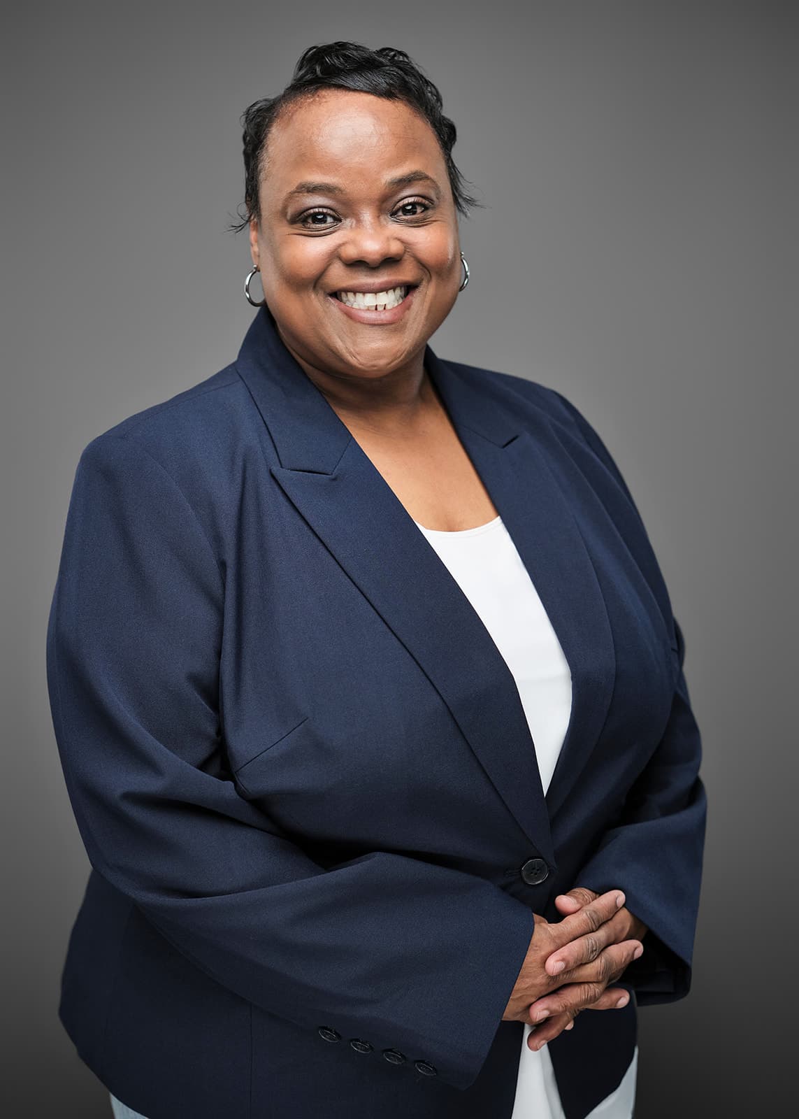 Matching staff headshot with controlled lighting for a firm-wide portrait program