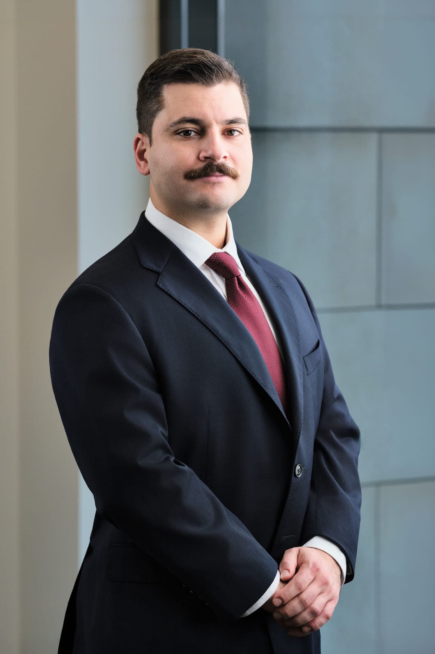 Washington University neurosurgery team member in business attire, environmental headshot in the WashU Medicine building in St. Louis by Henry David Photography