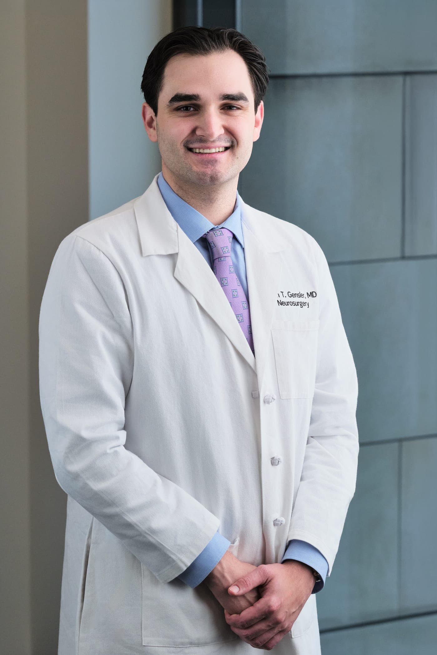 Washington University neurosurgery white coat headshot photographed in the WashU Medicine building in St. Louis by Henry David Photography