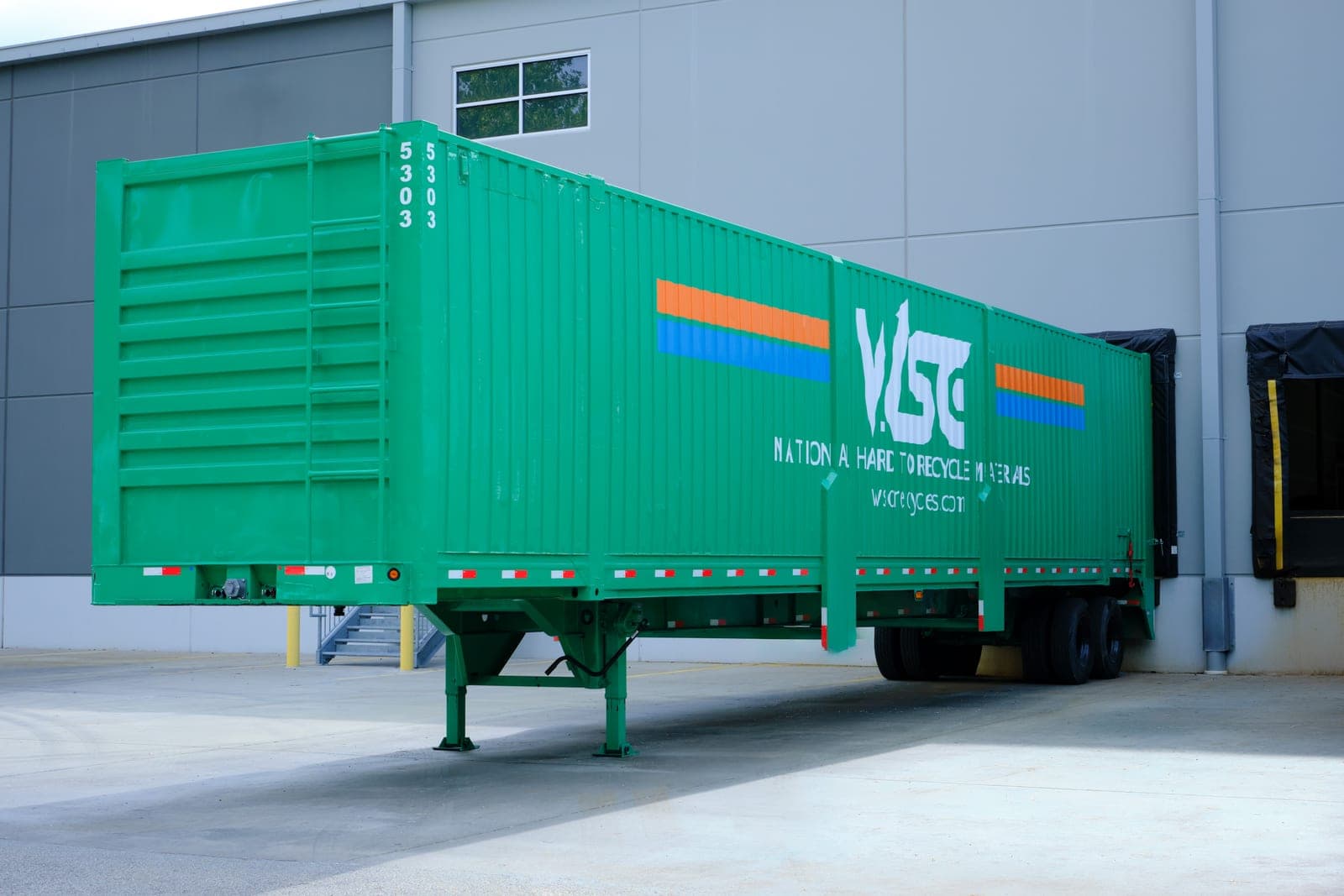 A green WSC trailer lettered National Hard to Recycle Materials parked at the loading docks, industrial facility photography in Bridgeton, Missouri